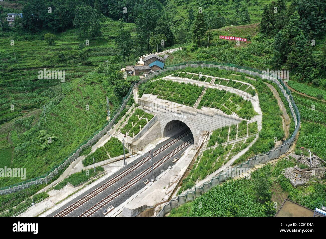 Liupanshui. 6th July, 2020. Aerial photo taken on July 6, 2020 shows a railway tunnel along the Anshun-Liupanshui railway in southwest China's Guizhou Province. The Anshun-Liupanshui intercity railway, with a designed speed of 250 km per hour, is being prepared for opening. The railway will shorten the travel time between Guiyang and Liupanshui from the current 3.5 hours to about 1 hour, and Liupanshui City will be fully connected with the national high-speed rail network. Credit: Liu Xu/Xinhua/Alamy Live News Stock Photo