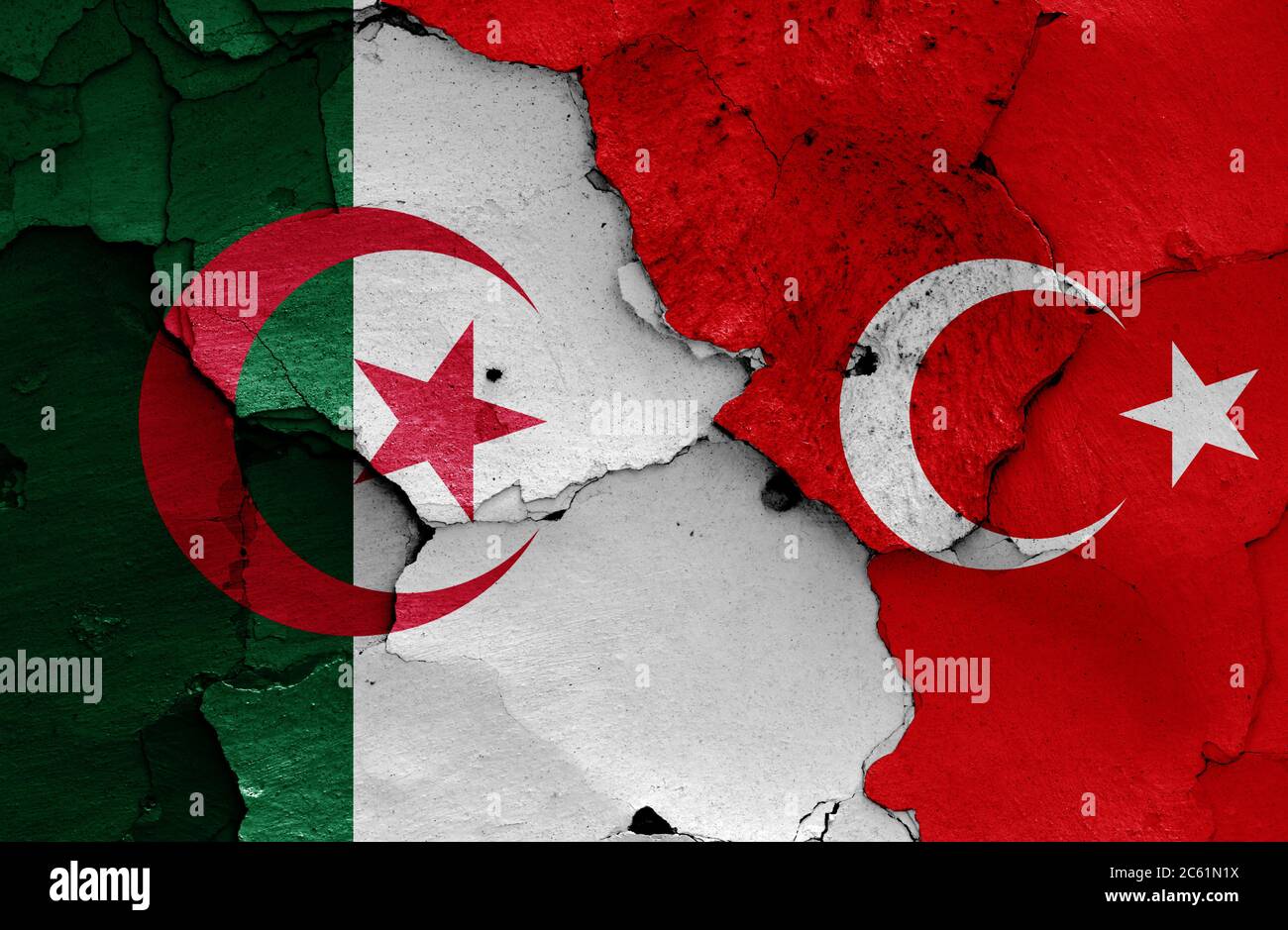 flags of Algeria and Turkey painted on cracked wall Stock Photo