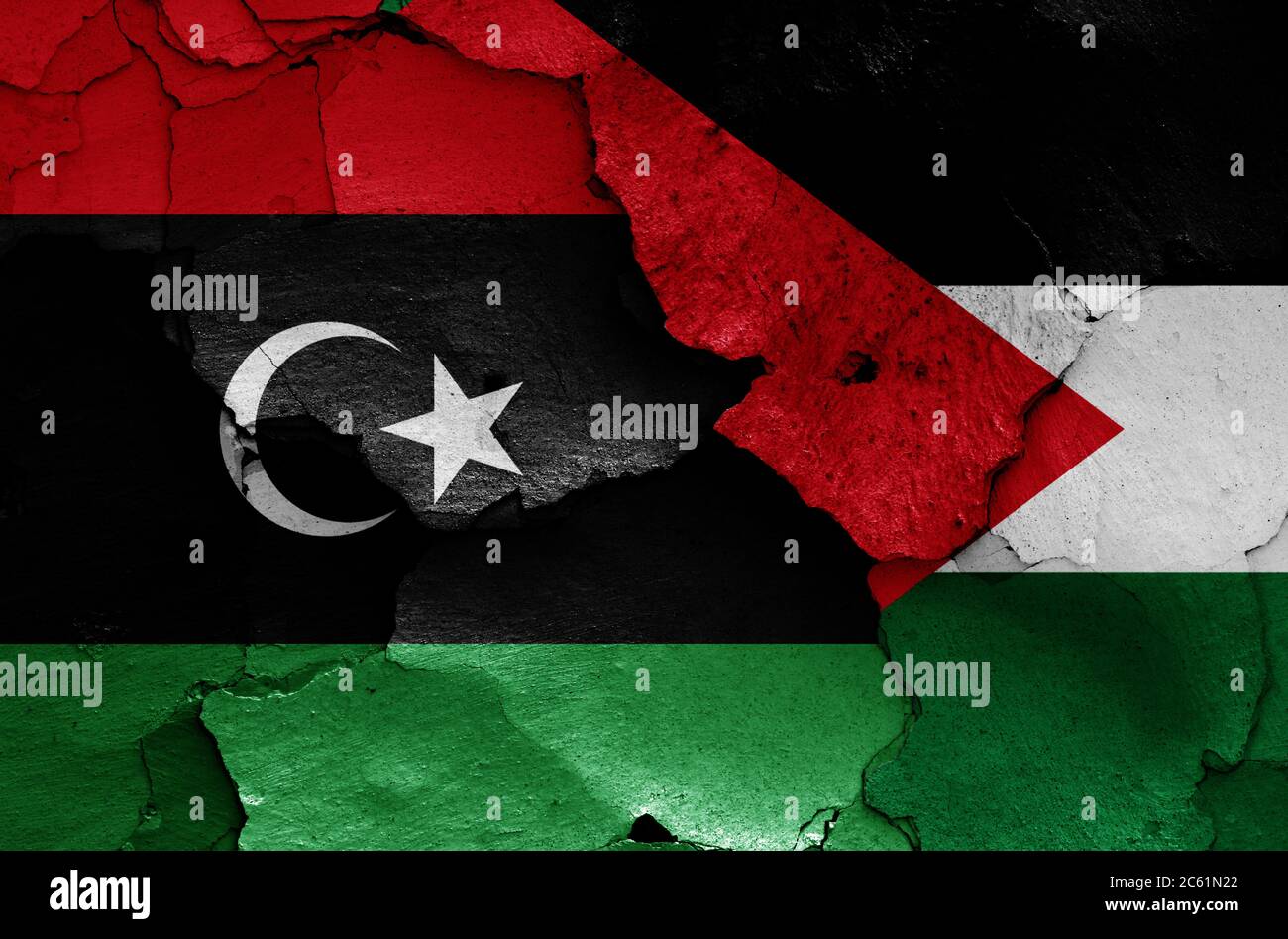 flags of Libya and Palestine painted on cracked wall Stock Photo