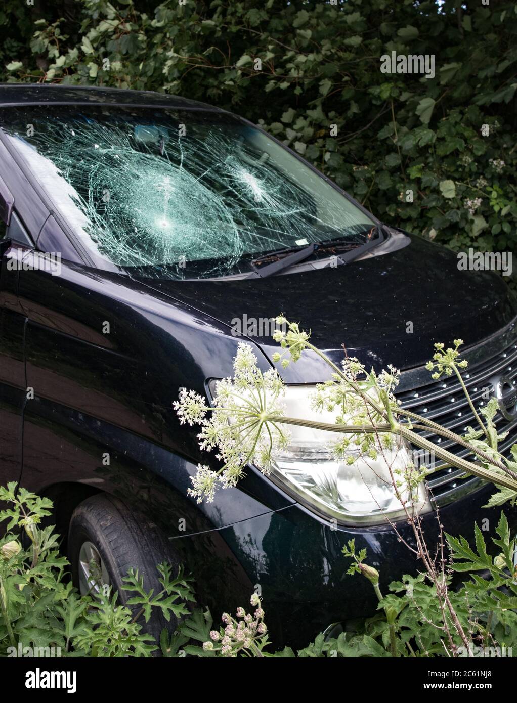 Vandalised car Smashed windscreen Hammer Bullets Stock Photo