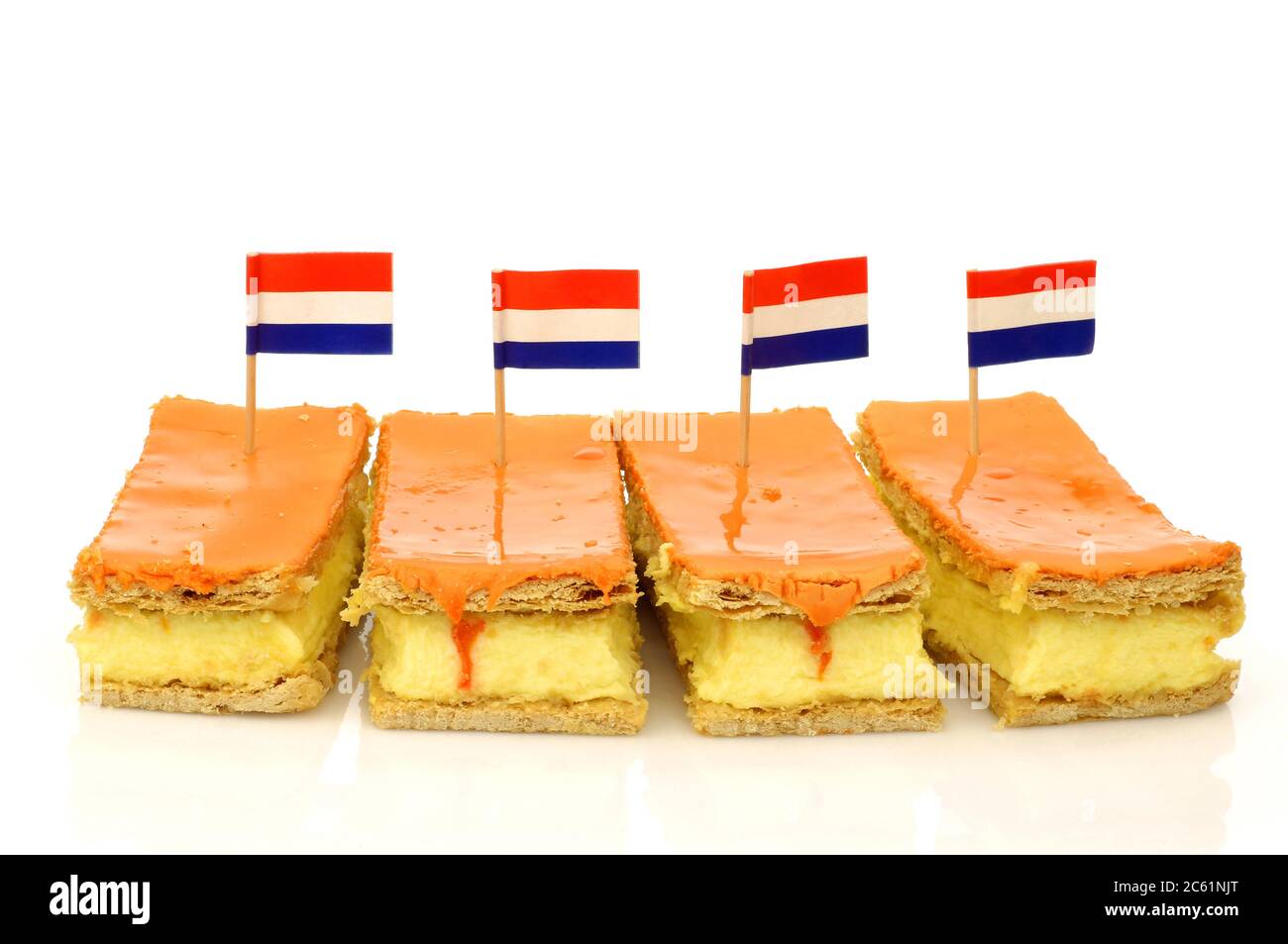 Traditional Dutch pastry called 'tompouce' with a Dutch flag especially produced for  Kings day on april 27th in Holland on a white background Stock Photo