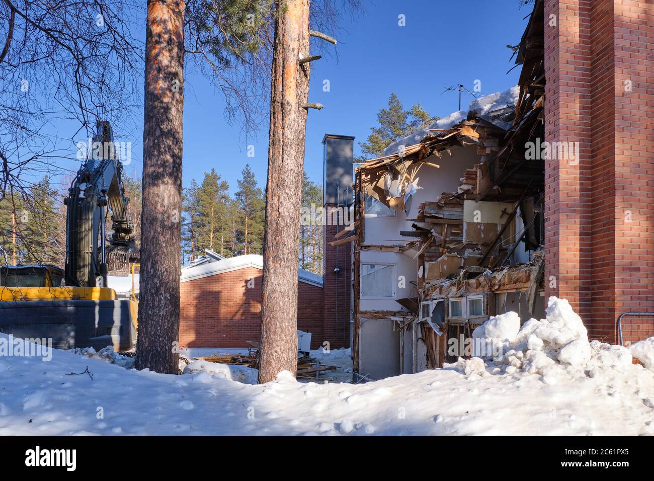 Bulldozer demolished old building. Finalnd Stock Photo