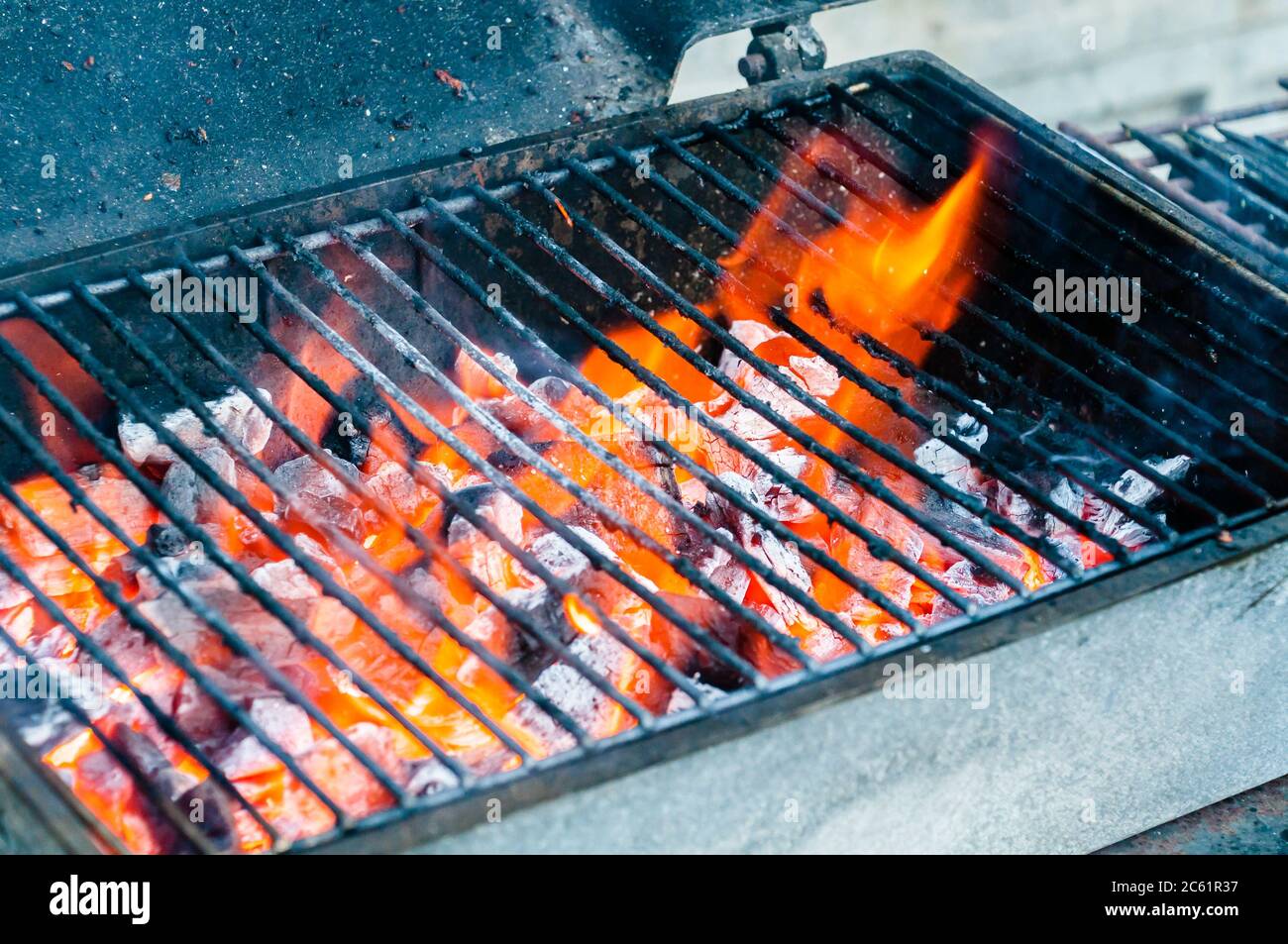 Hot empty portable barbecue BBQ grill with flaming fire and ember ...