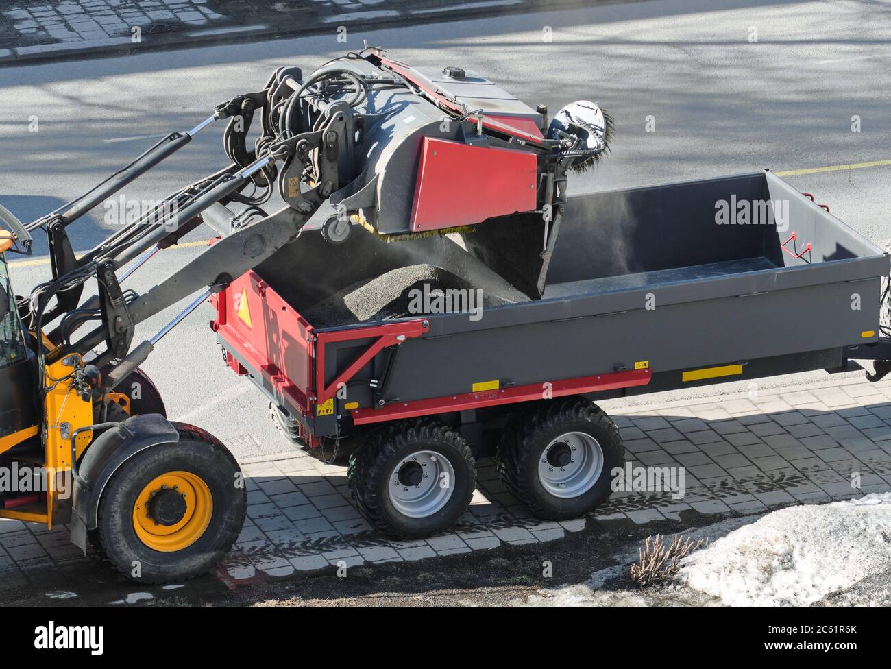 Street cleaning in spring after winter. Collecting gravel from the street in Finland. Stock Photo