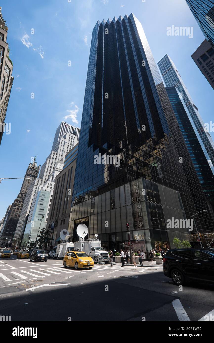 Low angle view of the Trump Tower skyscraper, home to Trump Organization, political headquarters, luxury offices and residences with TV News cars Stock Photo