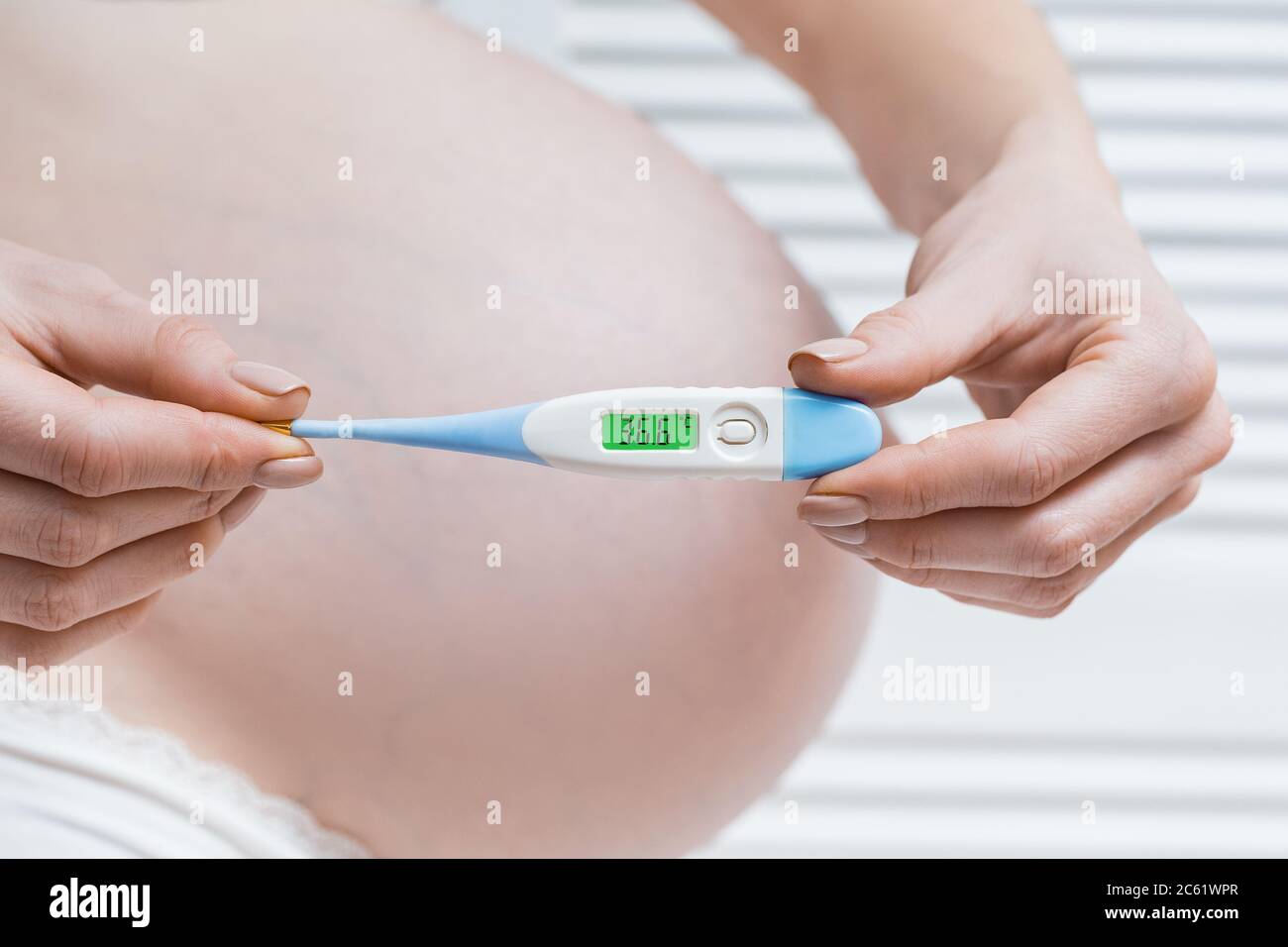 Pregnant Woman Holding Electronic Thermometer With Normal Temperature Health During Pregnancy Stock Photo Alamy