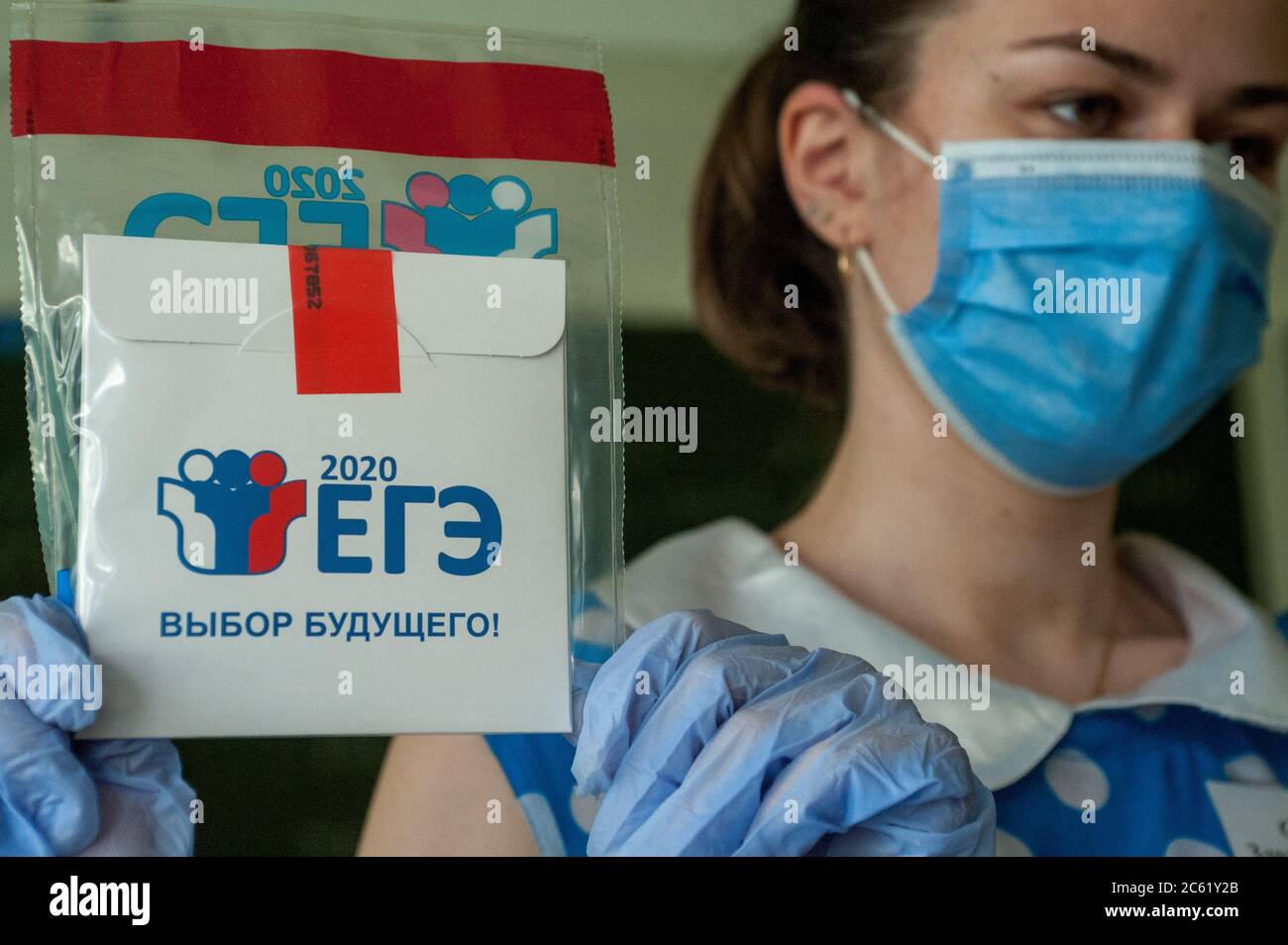 A worker holds a safe-bag with examination materials in a classroom at the gymnasium No.12 in Tambov.Students of Tambov (Russia) pass the Unified State Final Examinations in the Russian language. Stock Photo