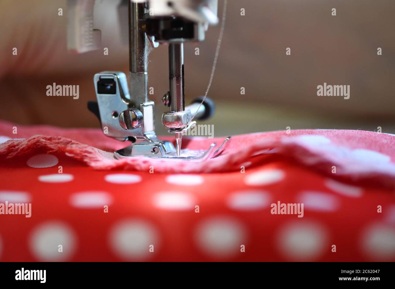 Sewing machine foot on material with threaded needle ready to sew Stock Photo Alamy