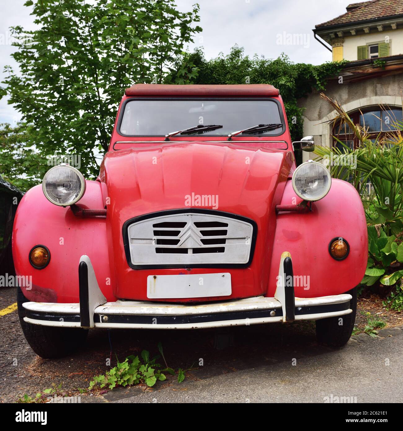 Vitznau, Switzerland - June 14, 2017: Red Vintage Citroen 2CV6 retro car named Duck on parking place at the city street. Stock Photo