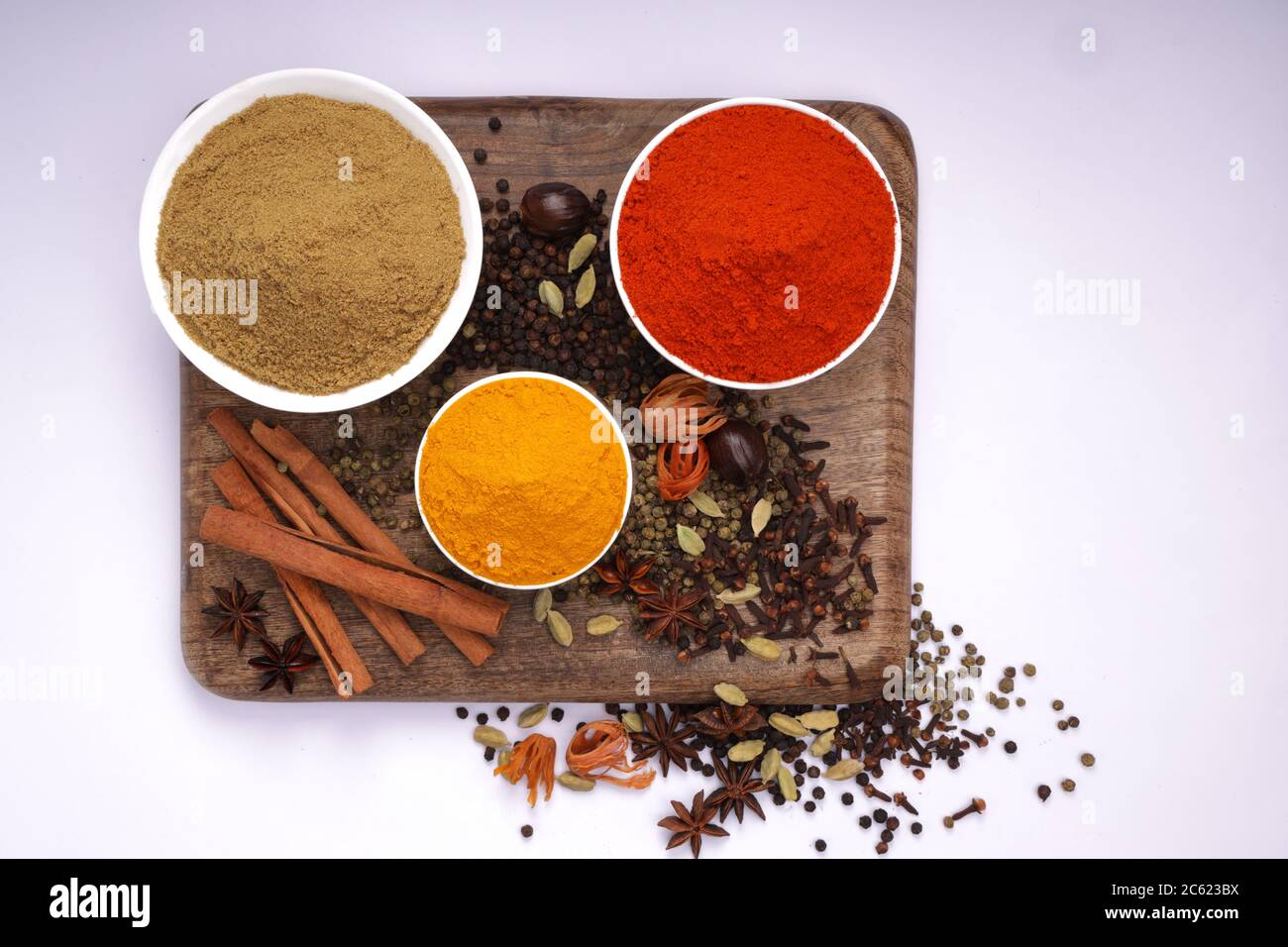 Top view of Dried Spices Black pepper,Green pepper,Mace or Javiithri flower,Nutmeg,Clove,Cinnamon,Cardamom,Star Anise ,red chilli,turmeric powder etc Stock Photo