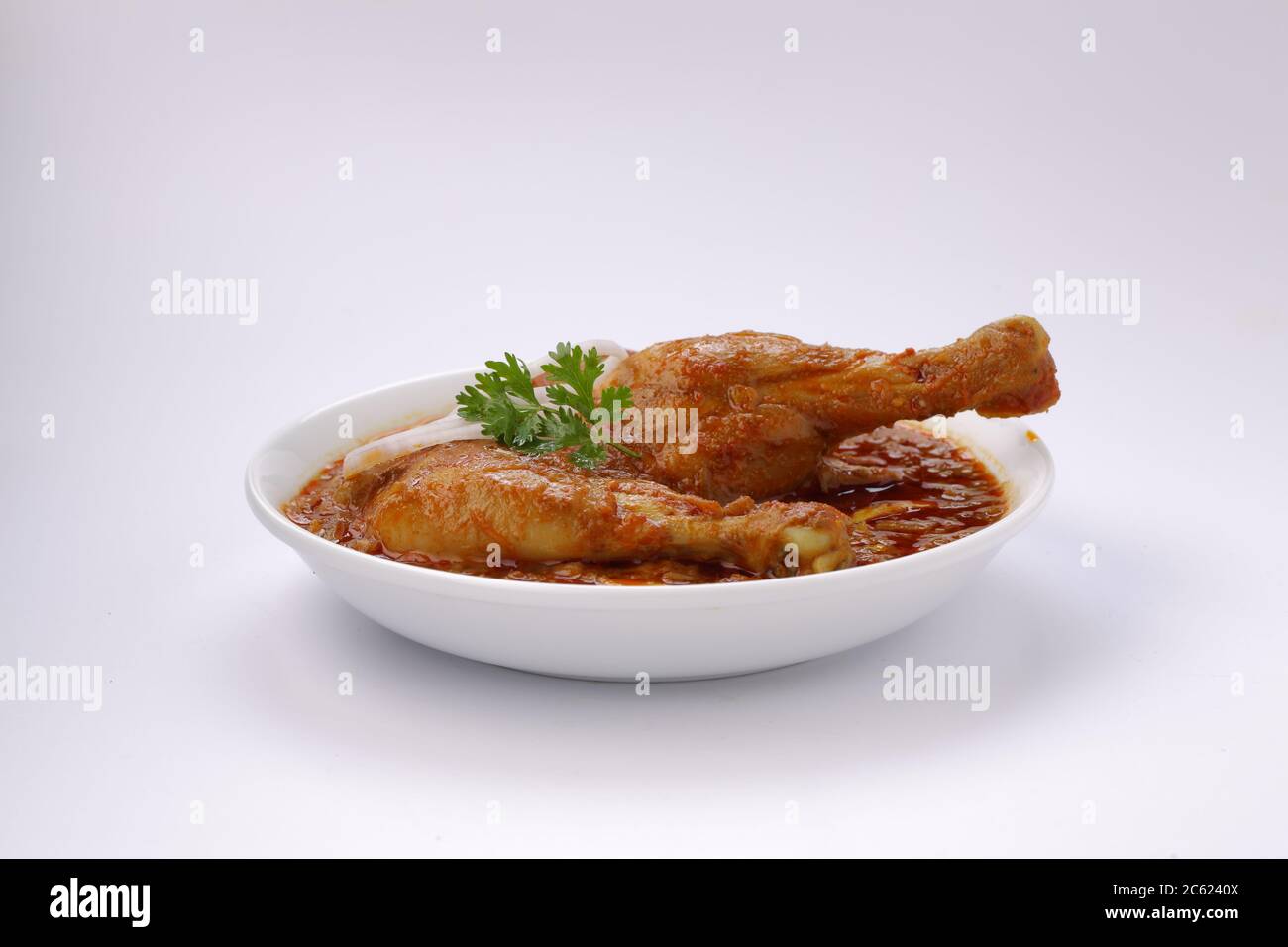 Chicken curry or masala , spicy reddish chicken leg piece dish