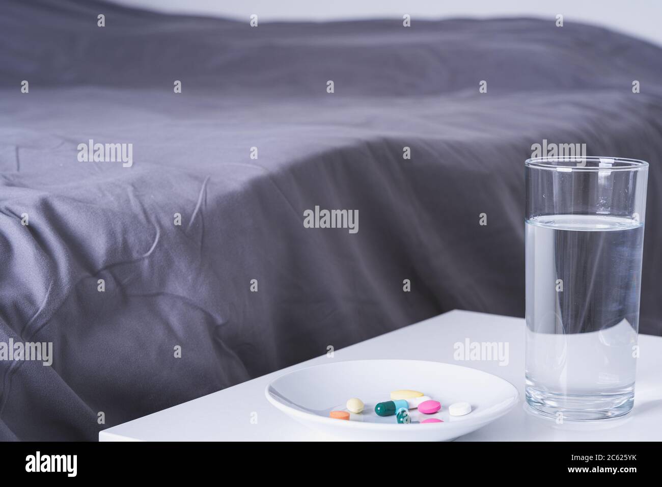 Close Up Pill Drugs In The Dish And A Glass Of Water On Nightstand In The Bedroom Healthcare And Medical Pharmacy Concept Stock Photo Alamy