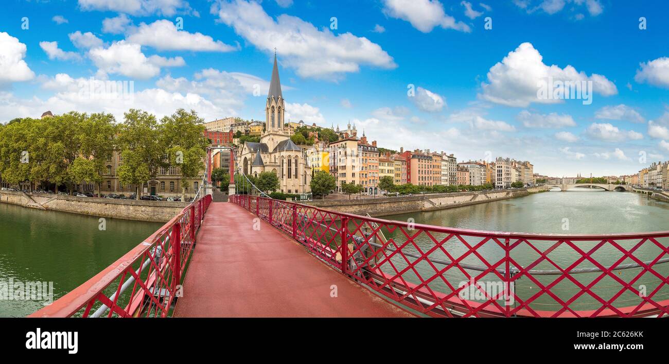 Pedestrian Saint Georges footbridge and the Saint Georges church in Lyon, France in a beautiful summer day Stock Photo