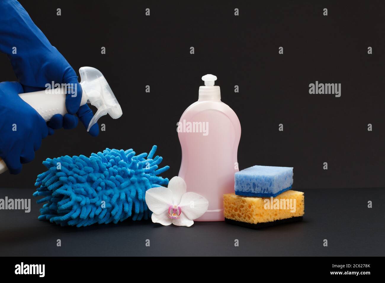 https://c8.alamy.com/comp/2C6278K/plastic-bottle-of-dishwashing-liquid-a-rag-sponges-and-a-hand-with-a-bottle-on-the-black-background-washing-and-cleaning-set-2C6278K.jpg