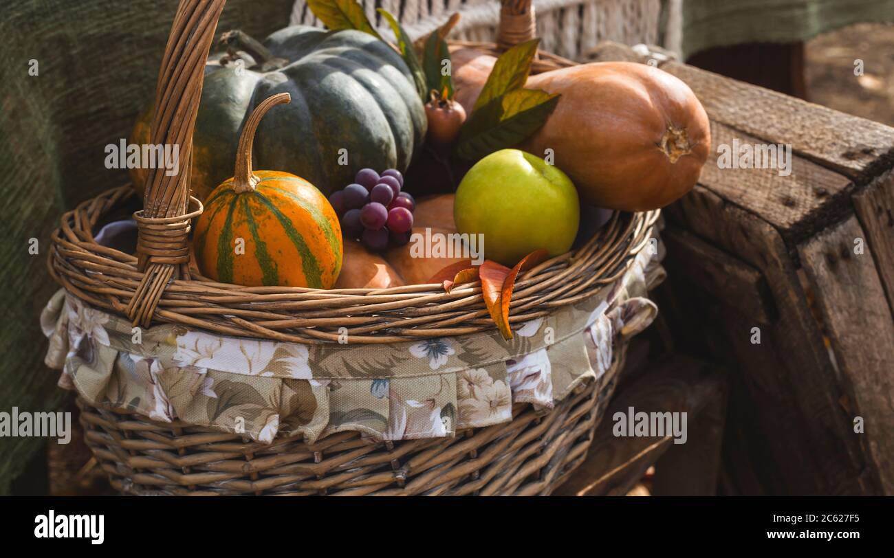 Beautiful basket with autumn rural harvest - pumpkins, apples and ...