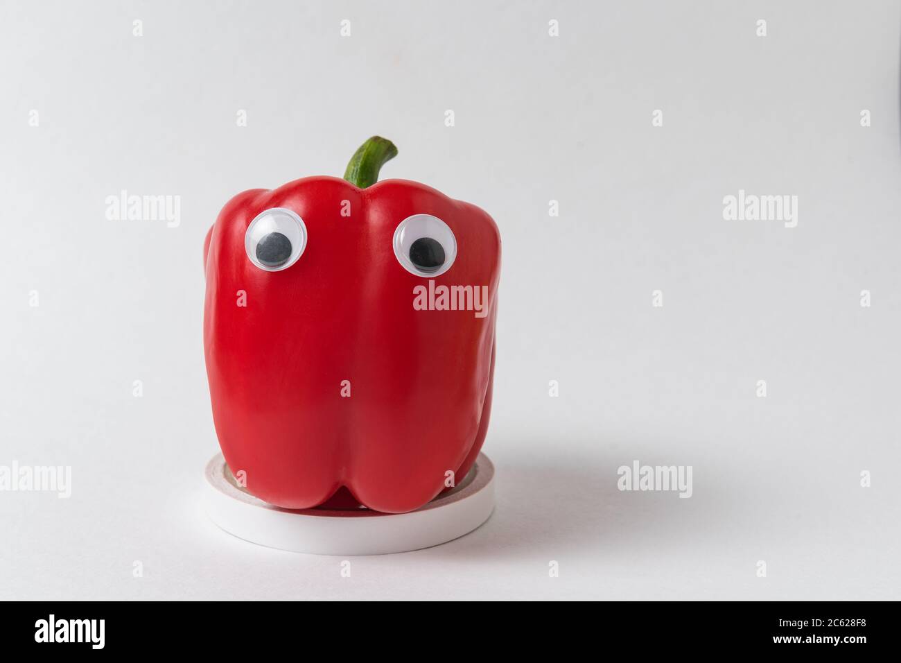 Red bell peppers with Googly eyes. Fresh Peppers with funny face Stock