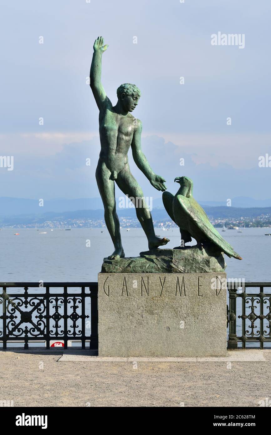Zurich Switzerland - June 14, 2017: Ganymed Statue (statue of a man and a eagle) in Zurich Switzerland - Lake Zurich panorama in the background Stock Photo