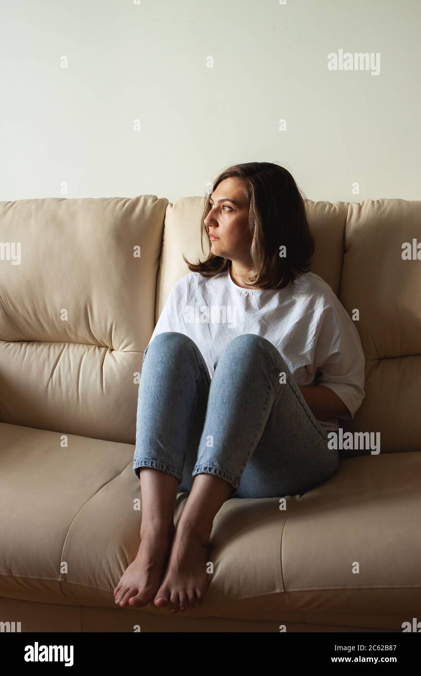 Young woman at home. The concept of natural beauty, femininity, feminism, body positive. Stock Photo