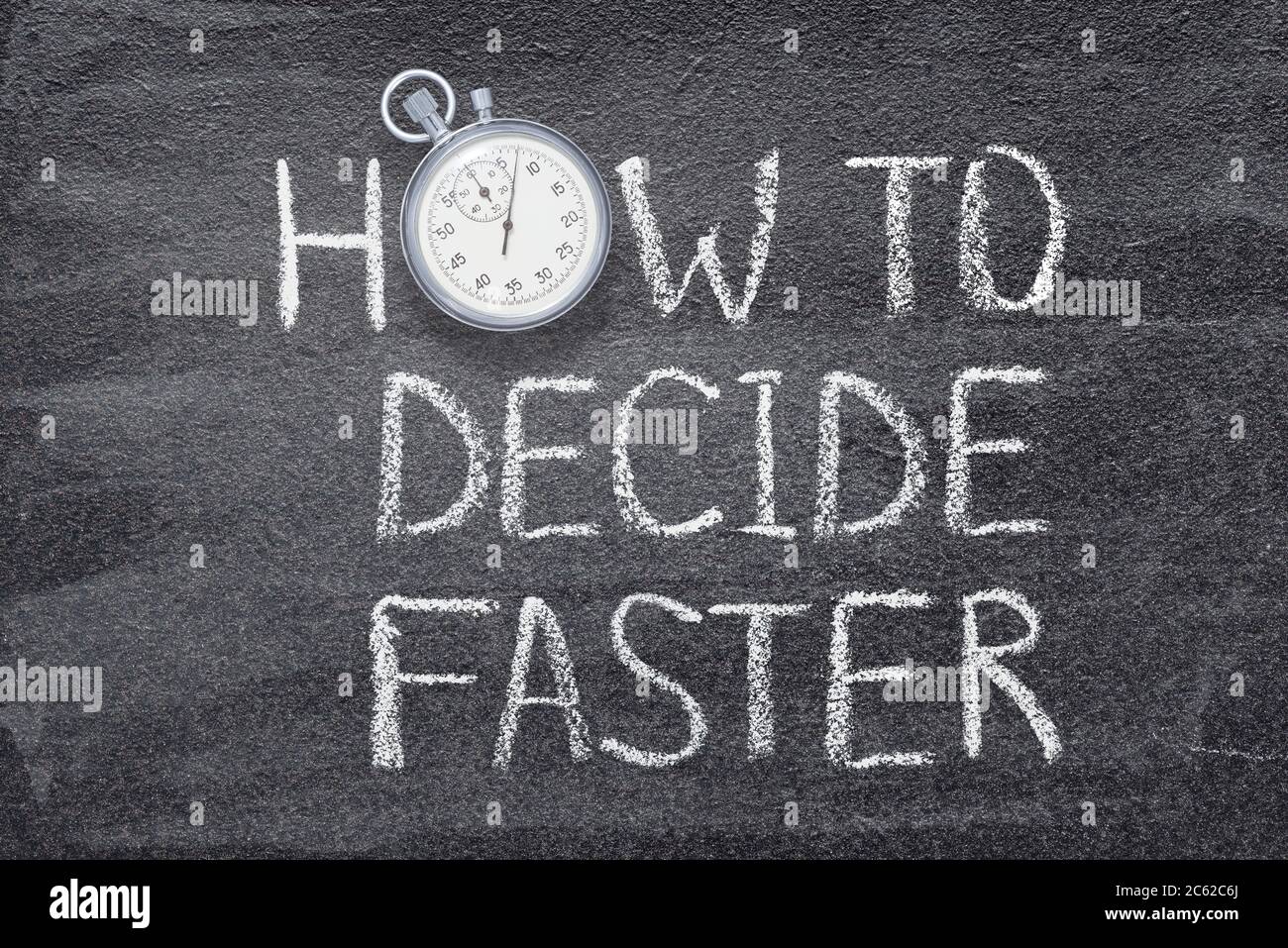 how to decide fast phrase written on chalkboard with vintage precise stopwatch Stock Photo