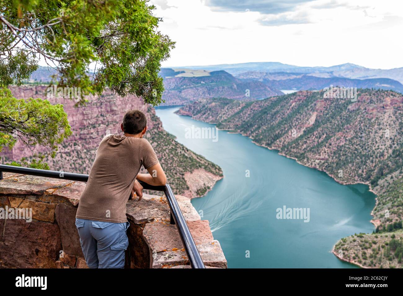 Canyon Rim Campground in Flaming Gorge Utah National Park of Green River high angle aerial overlook viewpoint in evening with man person looking at vi Stock Photo