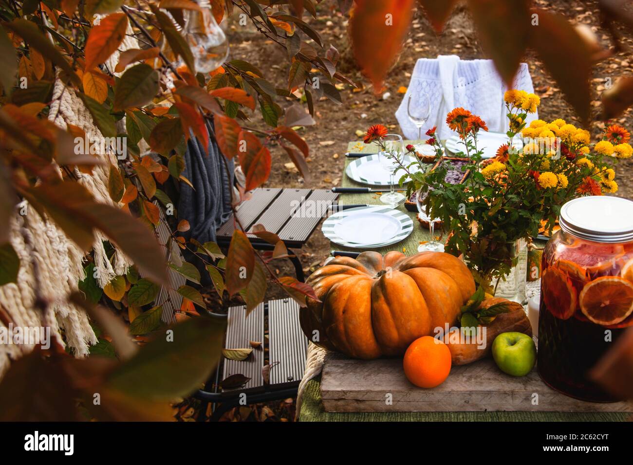 Autumn brunch table in the backyard with pumpkin and yellow decor Stock
