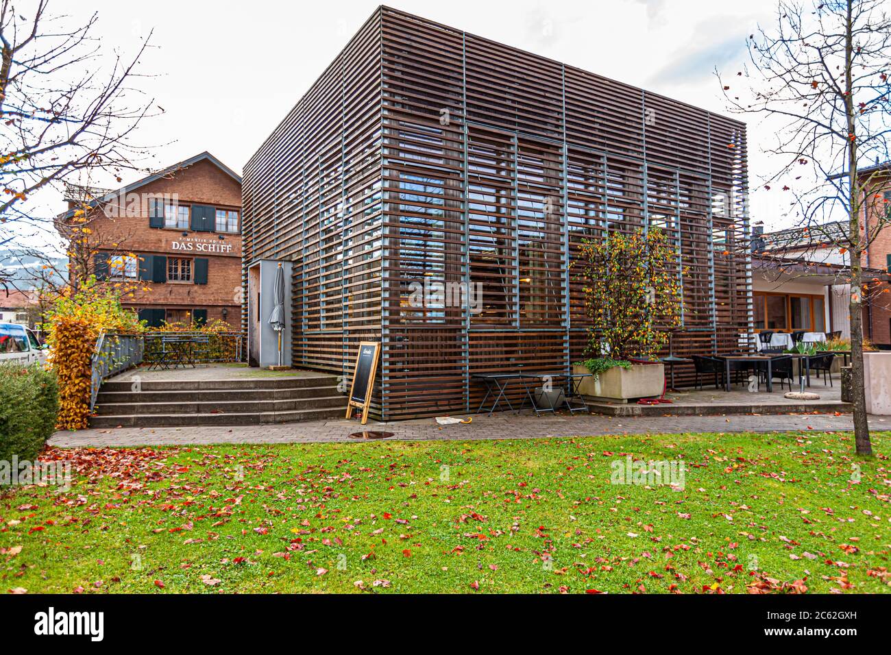 The modern building of the Ernerle restaurant in front of the main building of the hotel Das Schiff in Hittisau, Austria Stock Photo