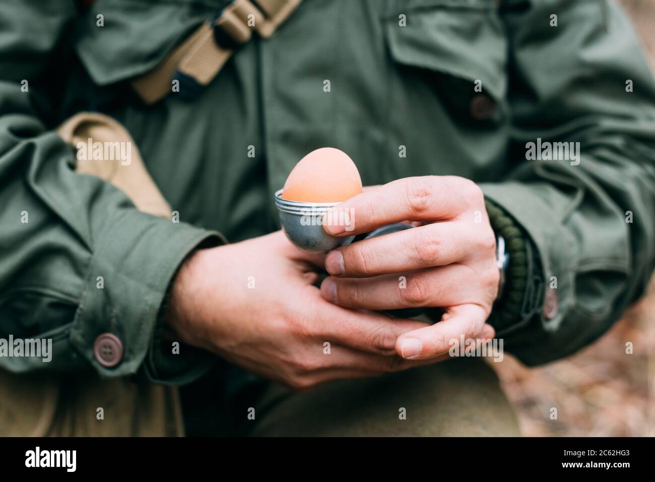 Soldier Of USA Infantry Of World War II Holds Egg Holder In Hands