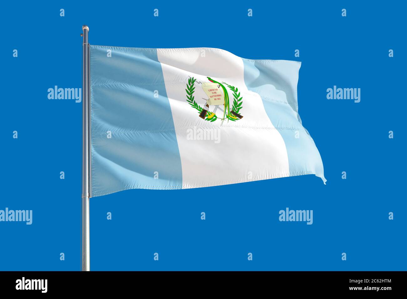 Guatemala national flag waving in the wind on a deep blue sky