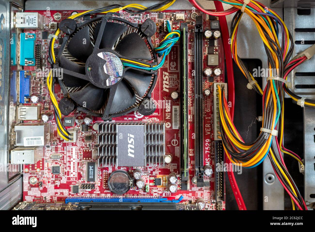 Ukraine - April 25, 2020: Computer motherboard with CPU coller inside the case. Hardware components. View inside, background Stock Photo