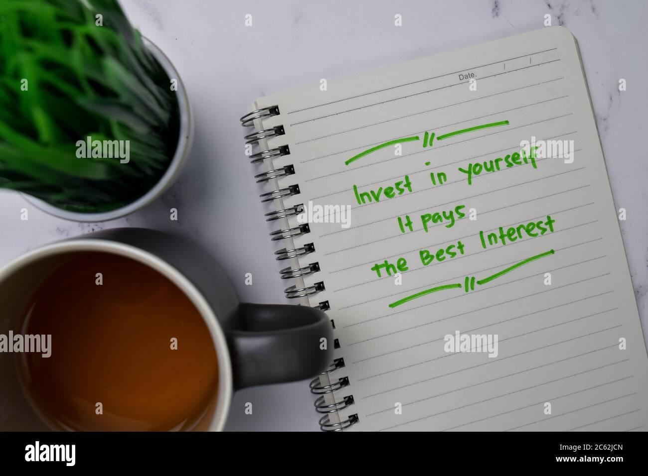 Invest In Yourself It Pays The Best Interest write on a book isolated wooden table Stock Photo