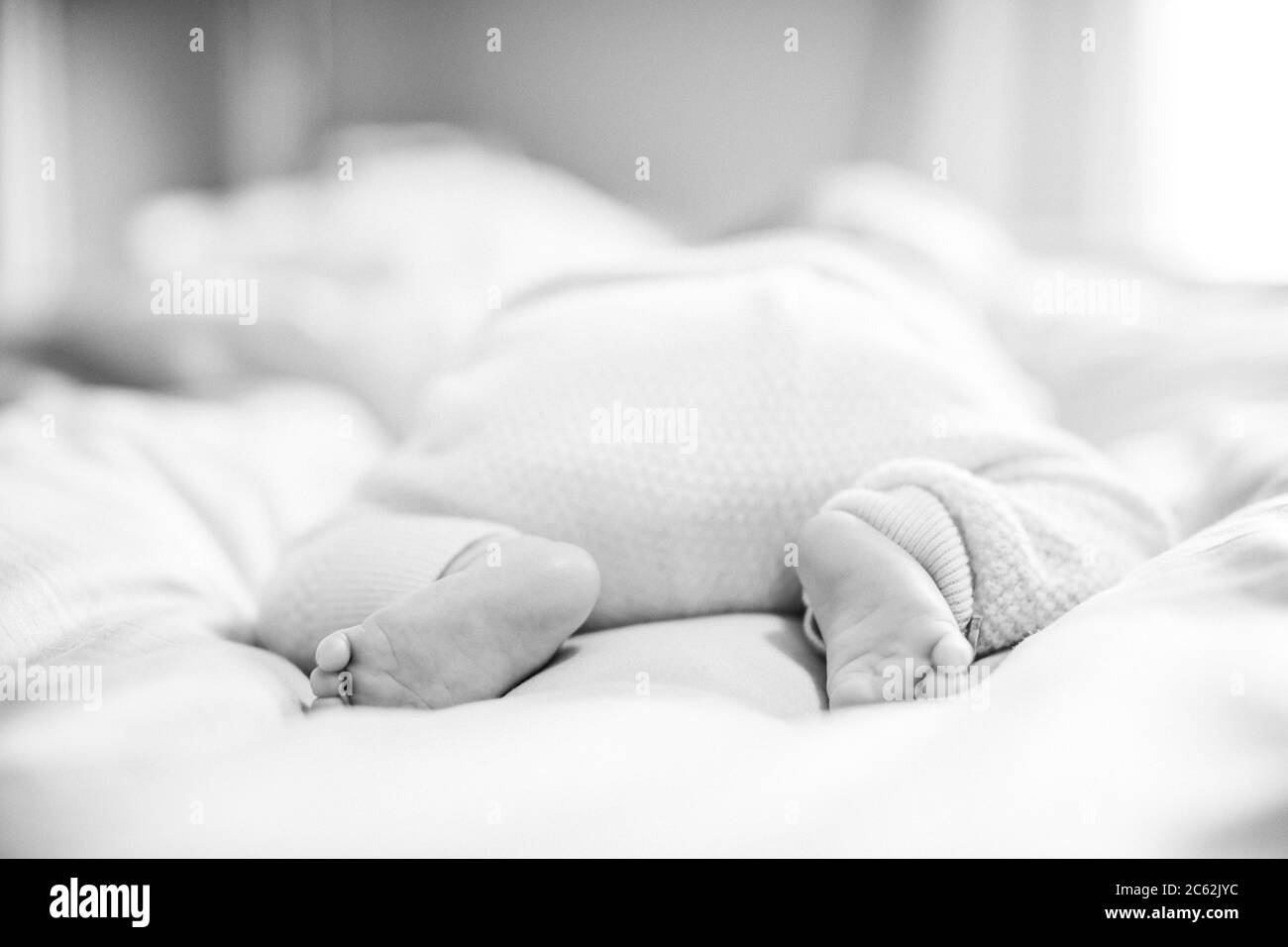 Close up of baby's feet. Baby sleeping on his belly. Newborn sleeping Stock Photo