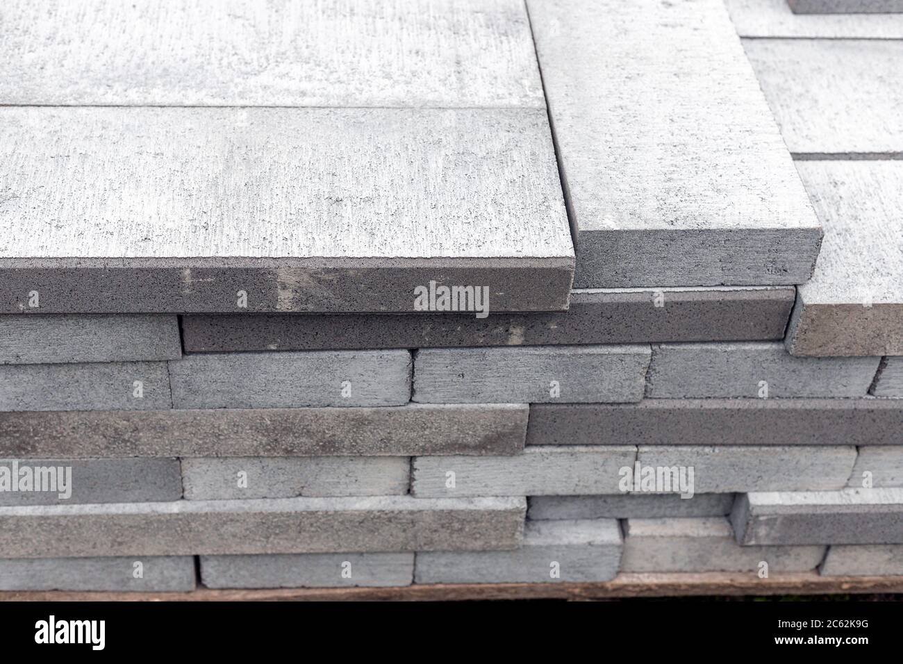 Closeup of new and grey driveway or path edgings on wooden pallet on a