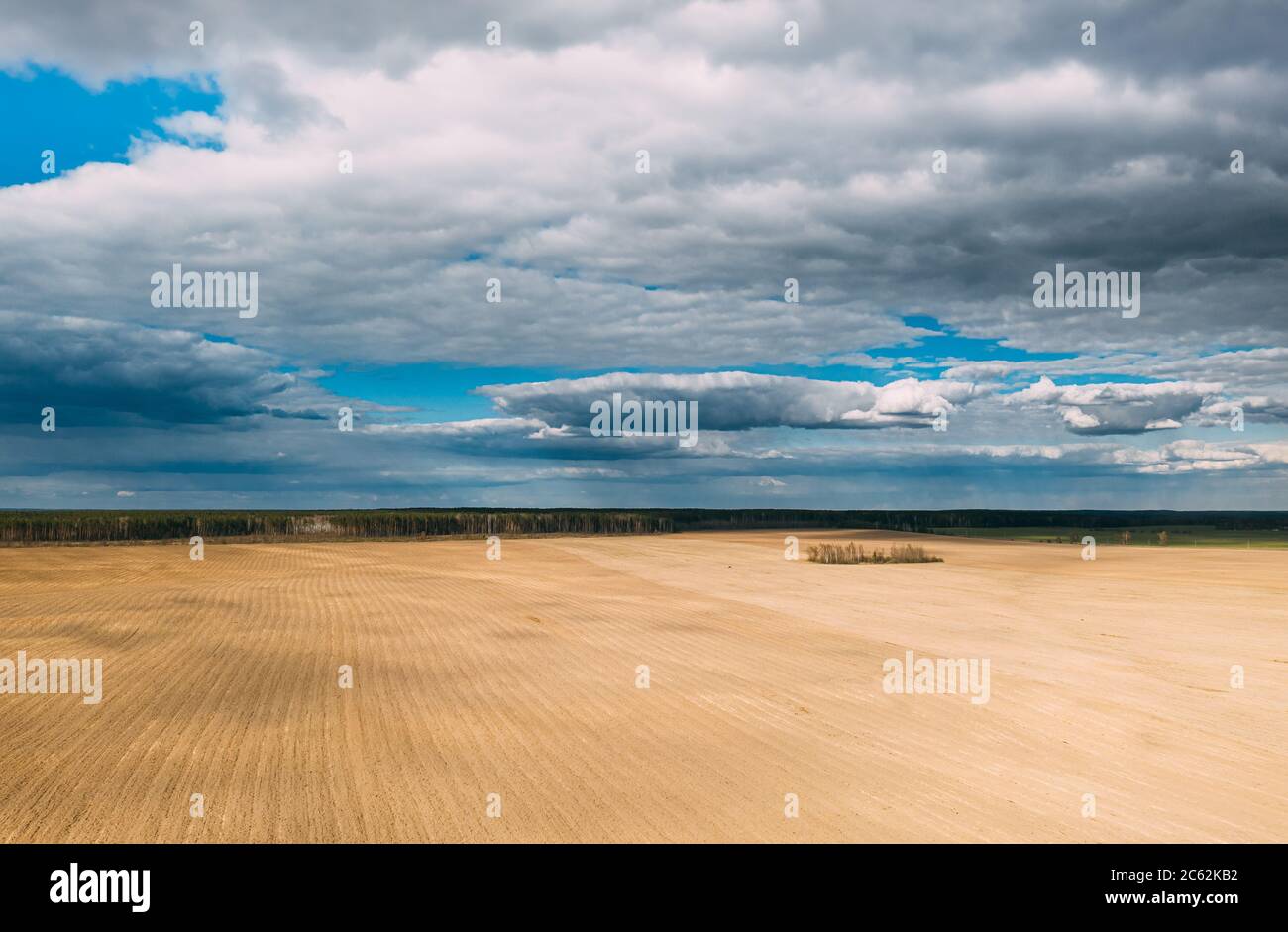 Aerial View. Amazing Natural Dramatic Sky With Rain Clouds Above Countryside Rural Field Landscape In Spring Day. Scenic Sky With Fluffy Clouds On Stock Photo