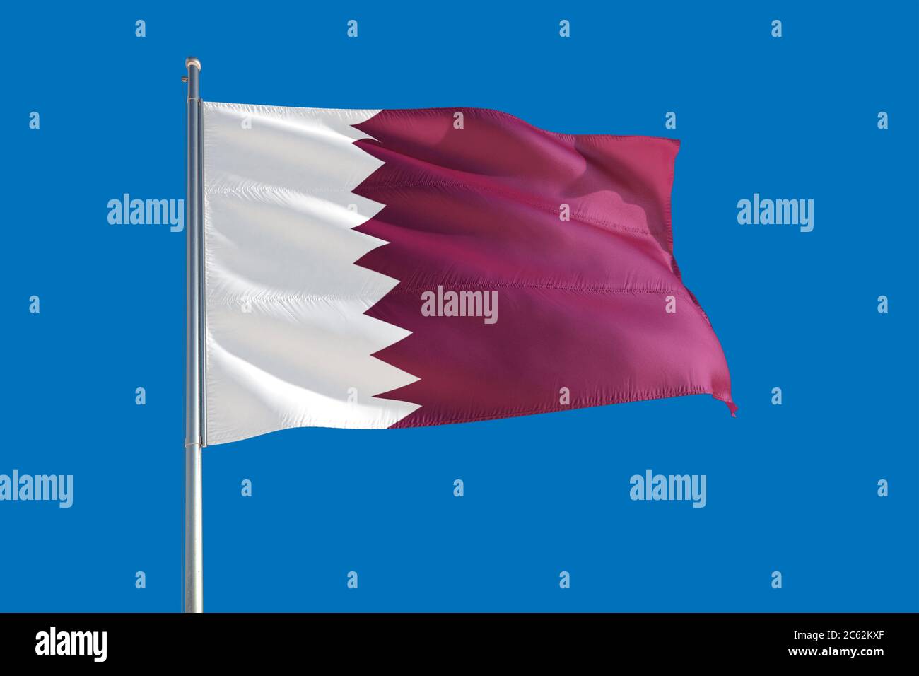 Qatar national flag waving in the wind on a deep blue sky. High quality ...