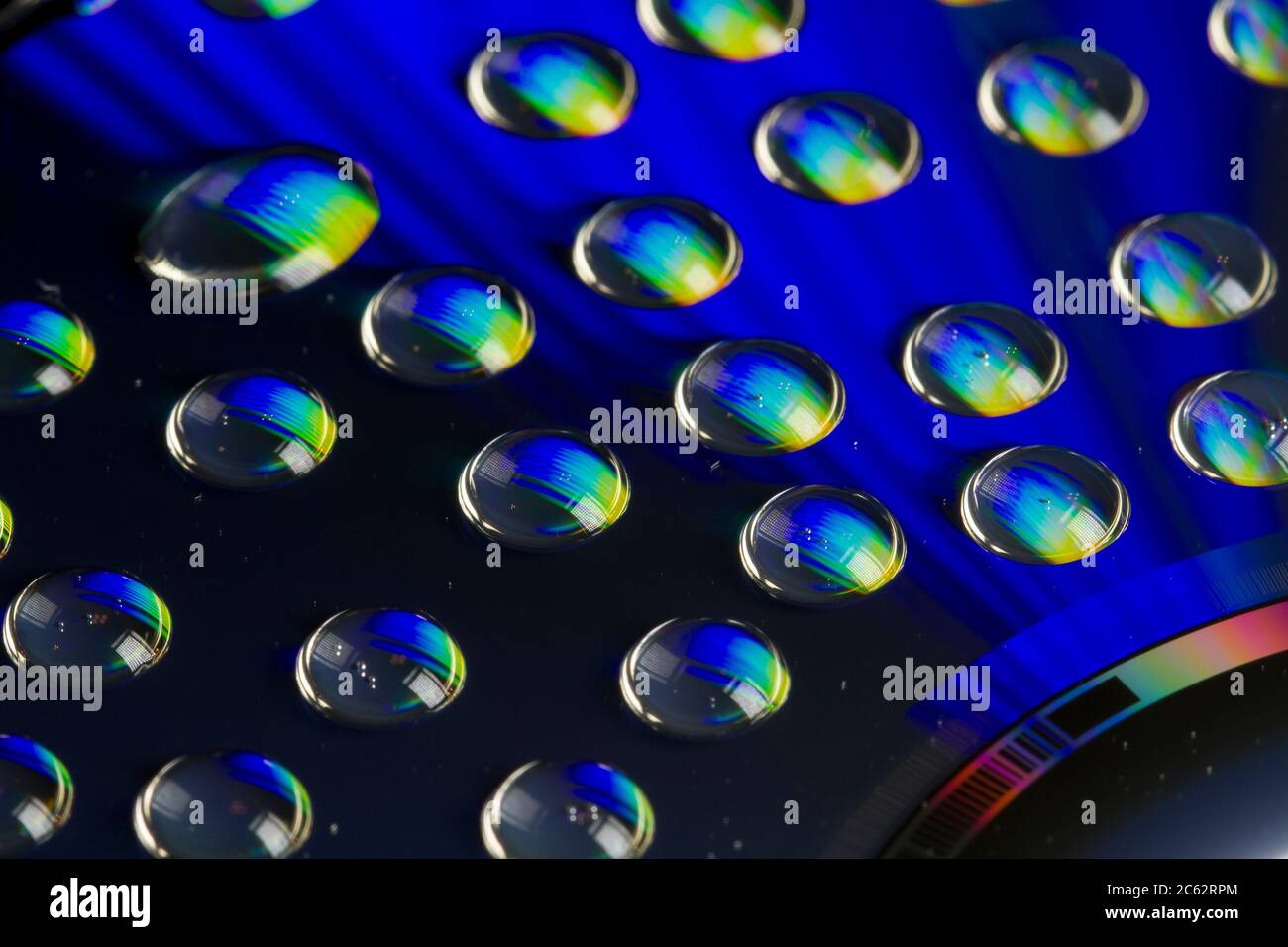 Macro shot of water drops on a CD surface for an abstract background ...