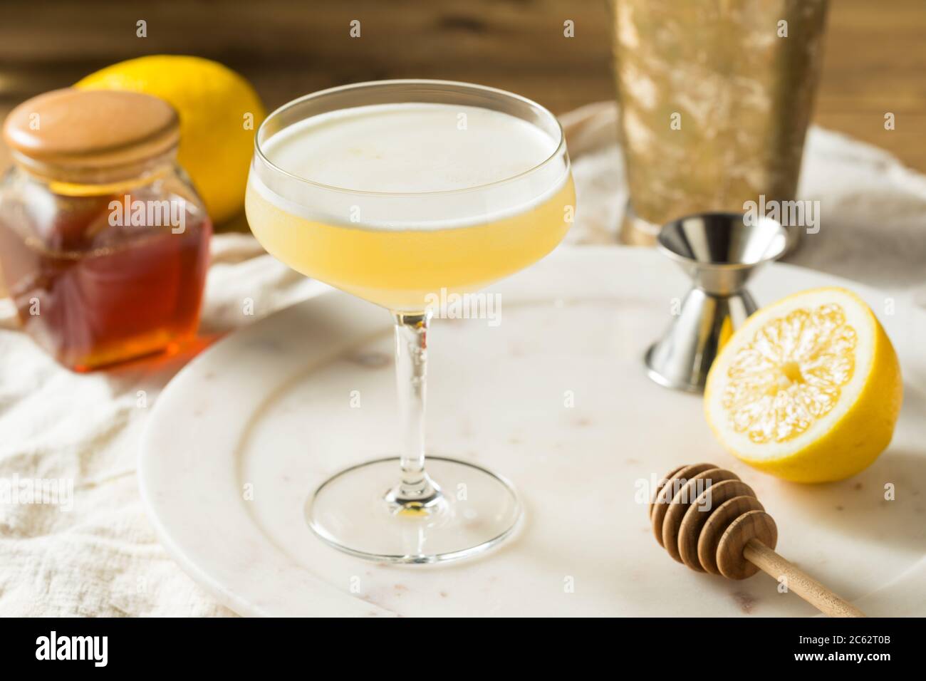 Boozy Bees Knees Gin Cocktail with Lemon Stock Photo Alamy