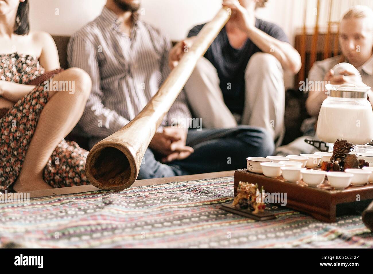 the tea ceremony is conducted by a tea master. tea party in the style of boho, hippie. tea cups on a special wooden coffee table. Preparation of masal Stock Photo