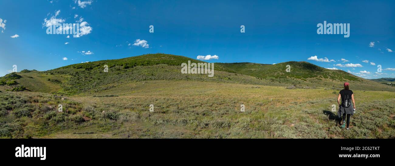 Panoramic view of woman hiking Utah mountains, USA Stock Photo