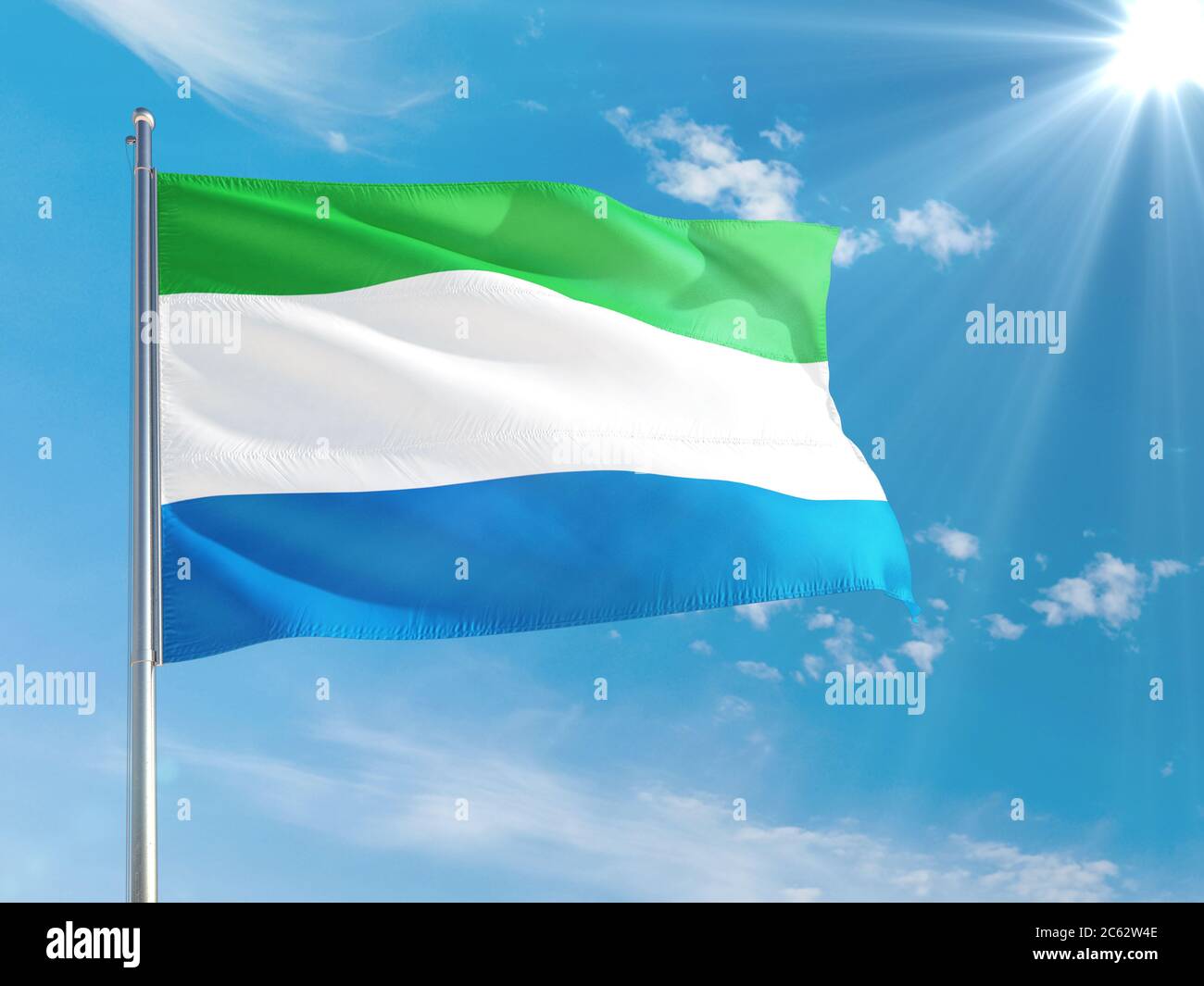 Sierra Leone national flag waving in the wind against deep blue sky ...