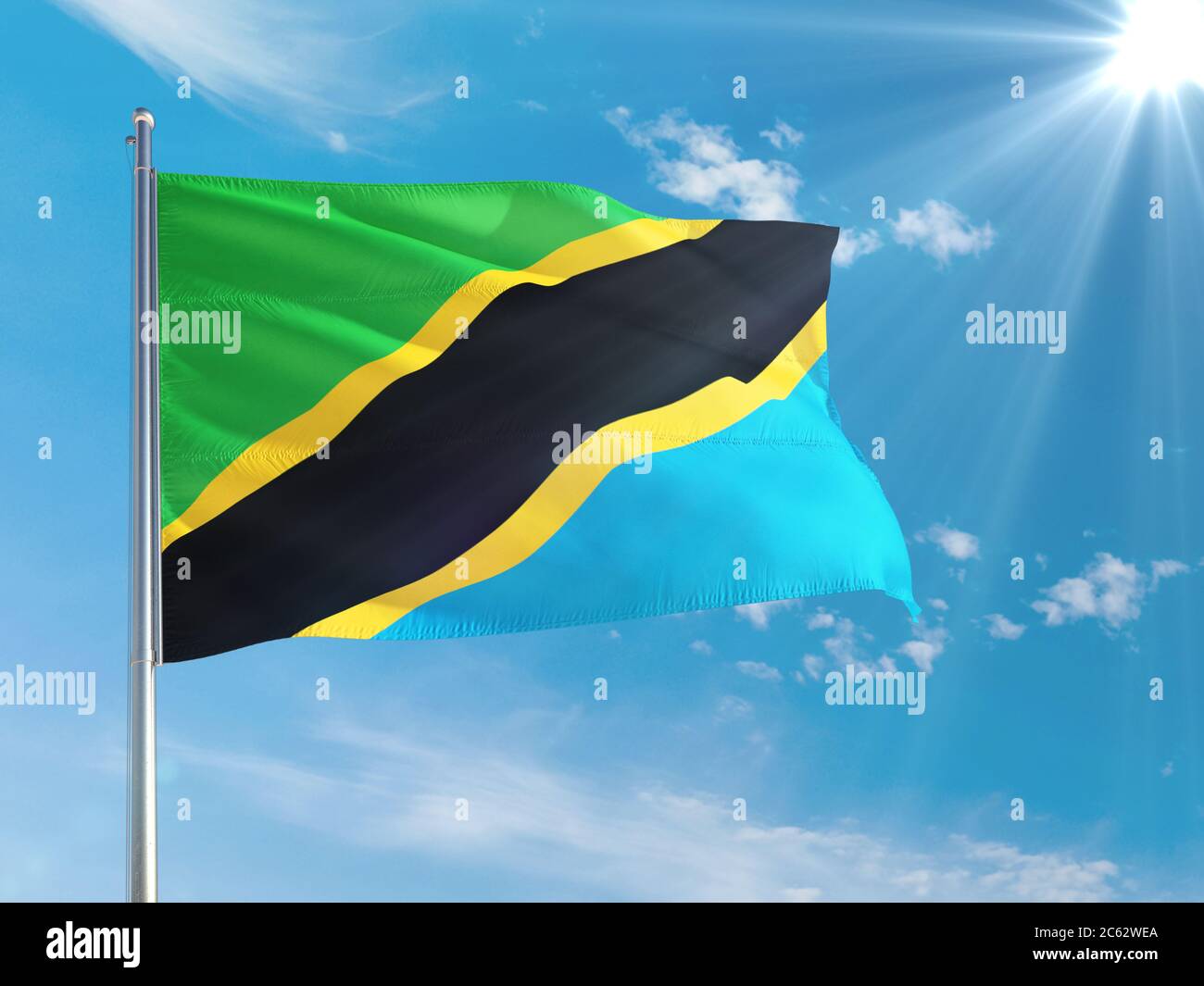 Tanzania national flag waving in the wind against deep blue sky. High ...