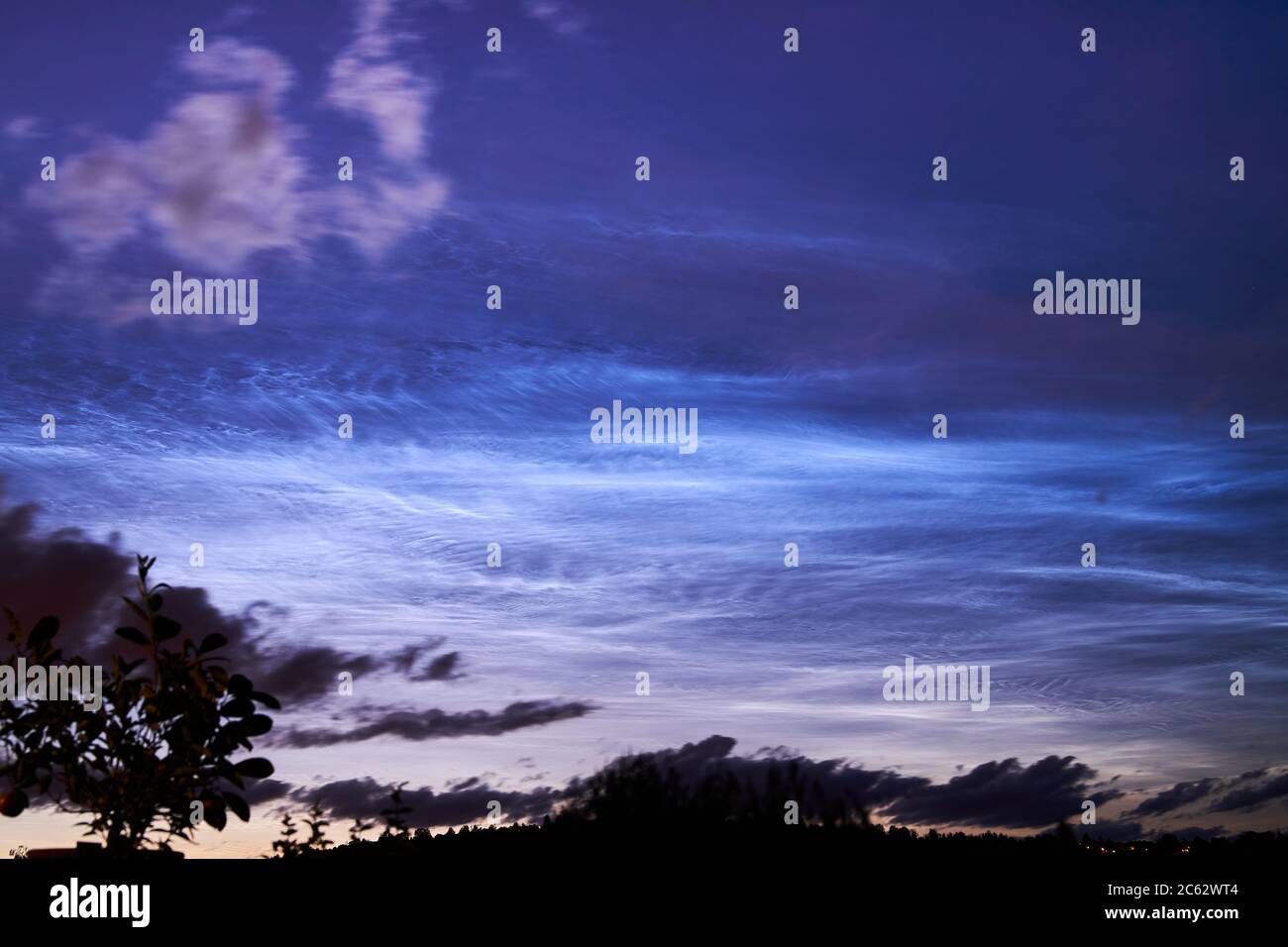 ice clouds in 80km height in the night sky over Stuttgart meteorological phenomenon Stock Photo
