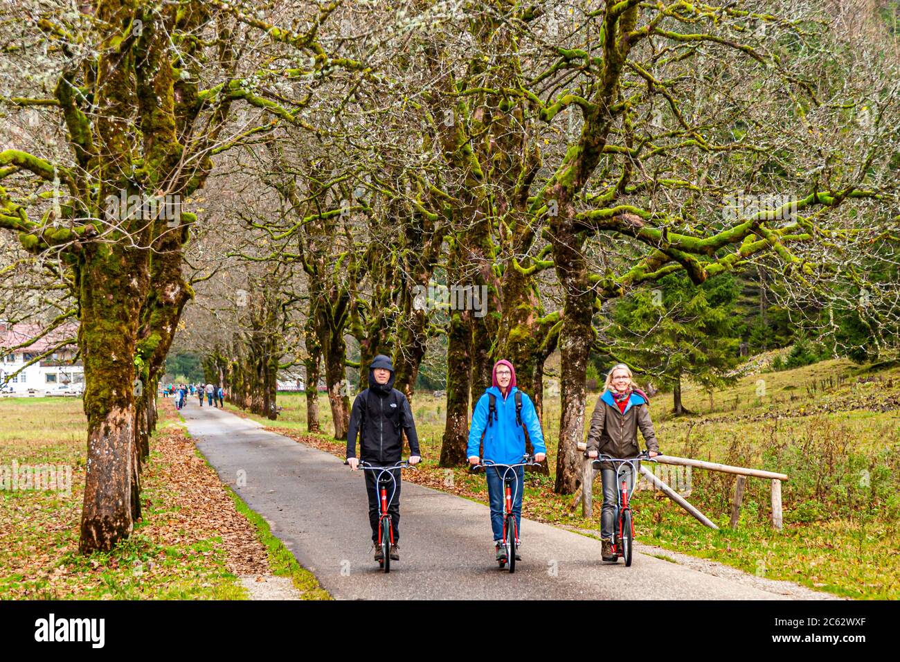 After the easy hike along the river Oy from Oberstdorf to the inn, the asphalted way back is best done with rental scooters. Oberstdorf, Germany Stock Photo