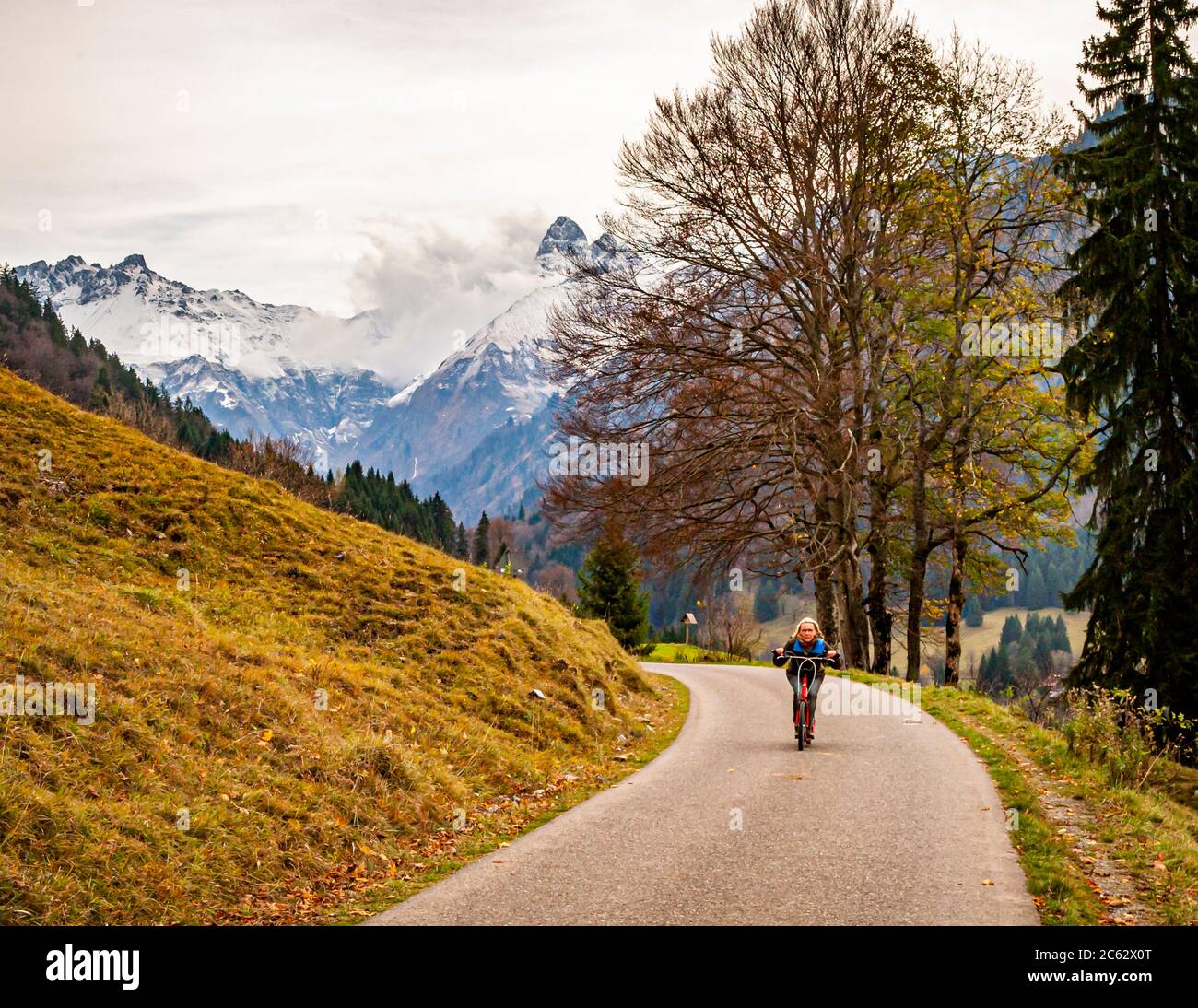 After the easy hike along the river Oy from Oberstdorf to the inn, the asphalted way back is best done with rental scooters. Oberstdorf, Germany Stock Photo