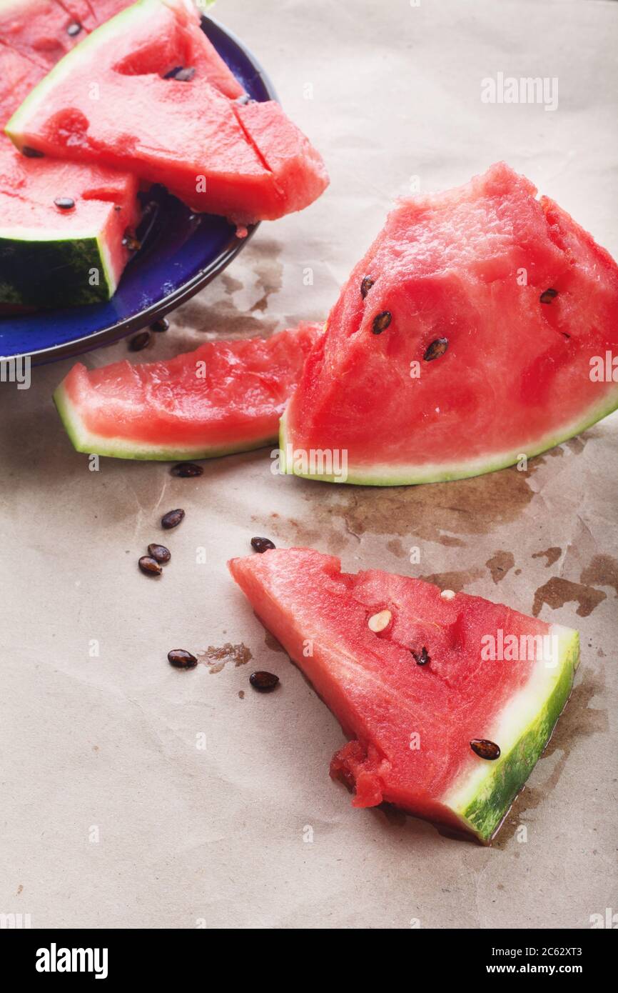 Juicy red watermelon slices lie on the table. Summer food, still life. Stock Photo