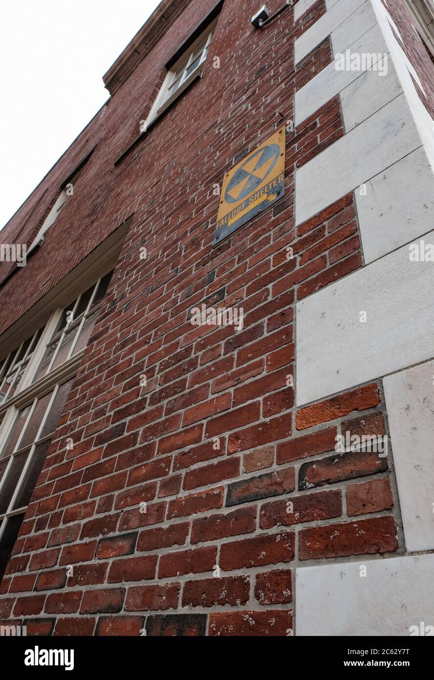 Vintage nuclear fallout sign seen fixed to a building in a US eastern town. Stock Photo