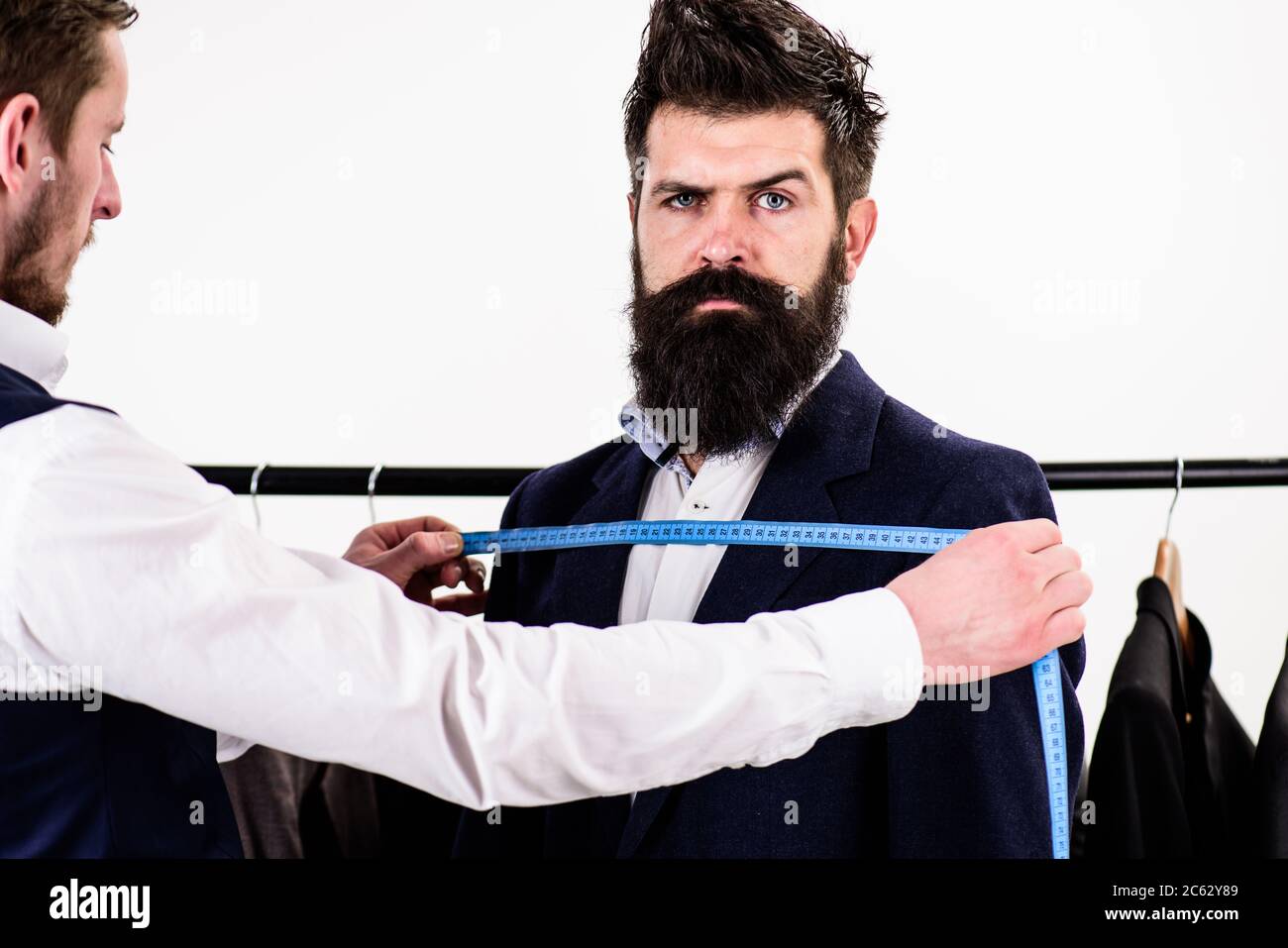 Tailor measure chest for sewing suit, white background. Client with