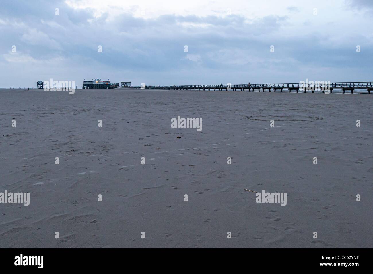 Beach of Sankt Peter-Ording, Germany. The pile dwellings rise up to seven meters above the beach. For more than 100 years, the constructions made of larch wood have shaped the beach image of St. Peter-Ording. Lake dwelling, pier house at the beach of St Peter Ording in Germany Stock Photo