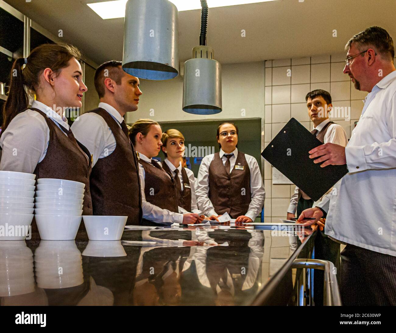 André Siegmann speaks to his service brigade before the guest appearance of the Michelin star chef Marco Müller in Sankt Peter-Ording, Germany Stock Photo