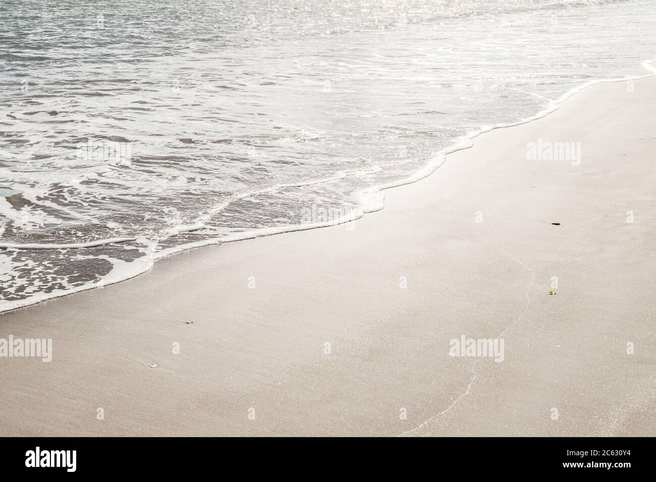 Ocean Wave on Sandy Beach Background Stock Photo - Alamy
