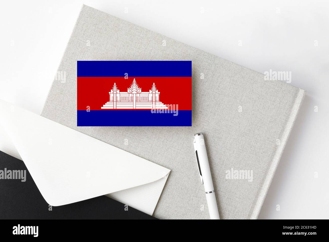 Cambodia flag on minimalist letter background. National invitation envelope with white pen and notebook. Communication concept. Stock Photo